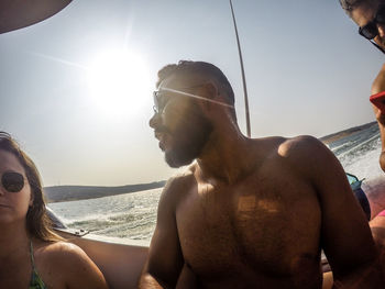 Young couple kissing against sky