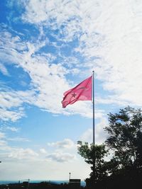 Low angle view of flag against sky