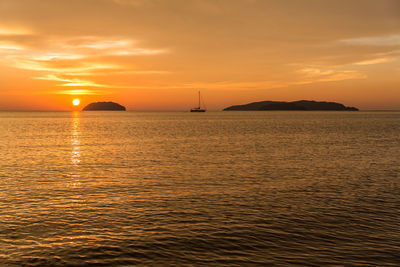 Scenic view of sea against romantic sky at sunset