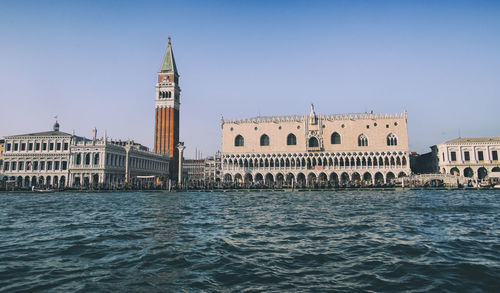 View of canal and buildings against sky