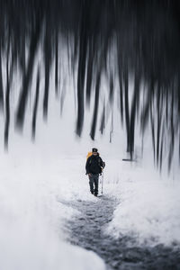 People skiing on snow covered field