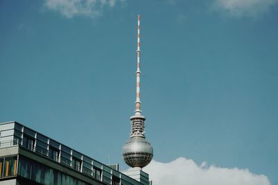 Low angle view of communications tower against sky