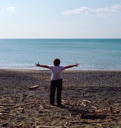 Rear view of man standing on beach