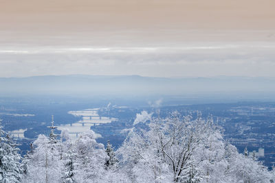 Aerial view of cityscape against sky during winter