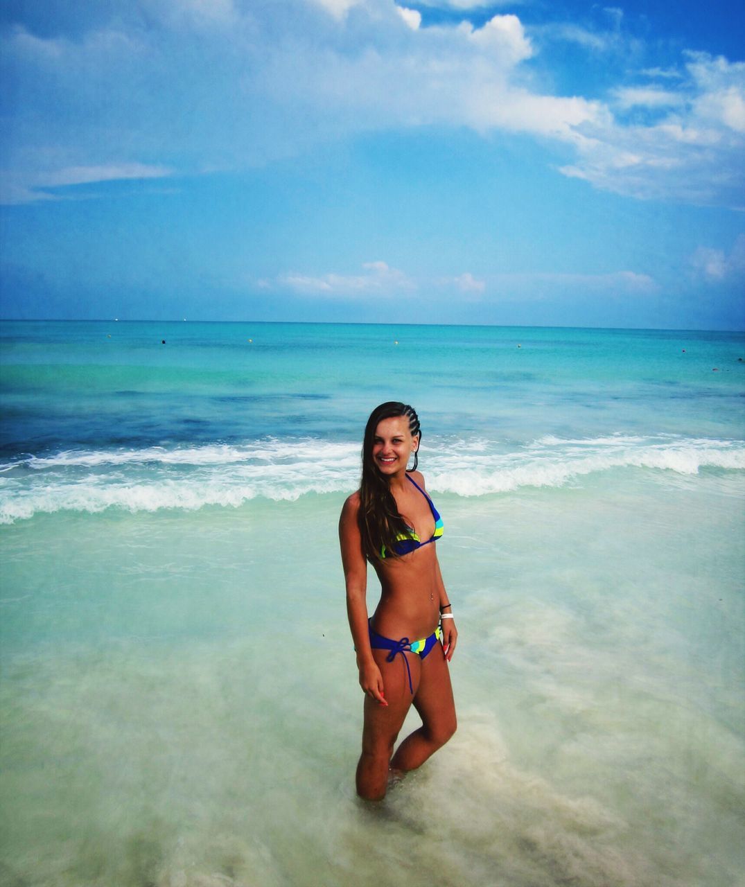 sea, horizon over water, young adult, water, young women, beach, lifestyles, leisure activity, sky, person, vacations, looking at camera, portrait, shore, beauty in nature, scenics, sunglasses, front view