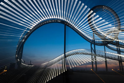 View of suspension bridge against blue sky