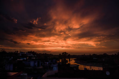 Silhouette buildings against sky during sunset