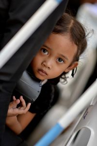 Close-up portrait of cute girl in car