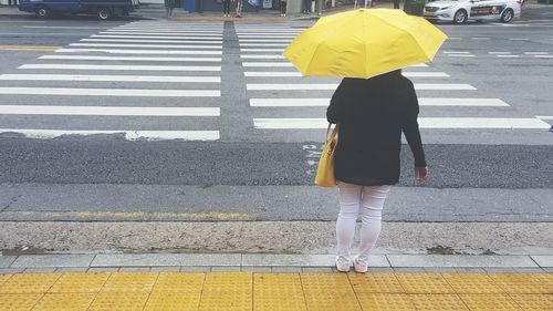 Rear view of woman walking on street