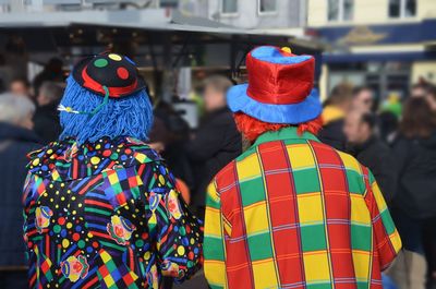 Rear view of men in costumes during celebration in city