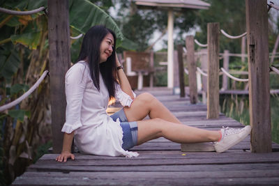 Portrait of young woman sitting outdoors