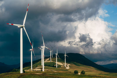 Windmill on field against sky