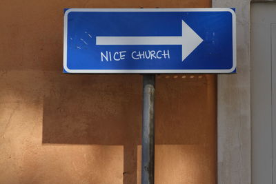 Close-up of road sign on wall