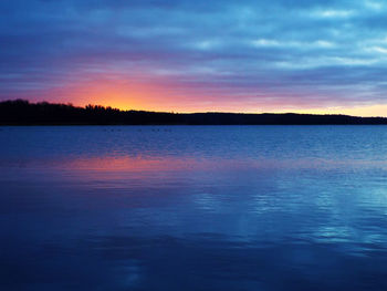 Scenic view of lake at sunset