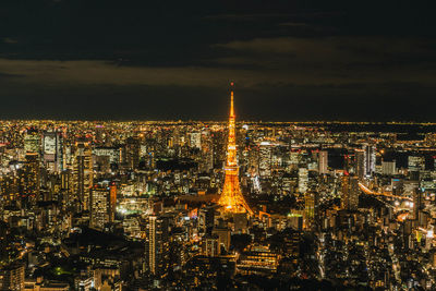 High angle view of illuminated cityscape against sky at night