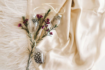 Easter eggs with flowers on white linen fabric.