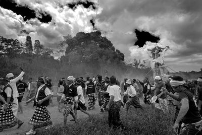 Group of people in traditional clothing against sky