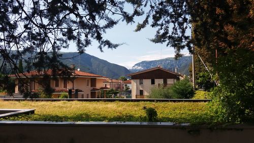 Houses on mountain against sky