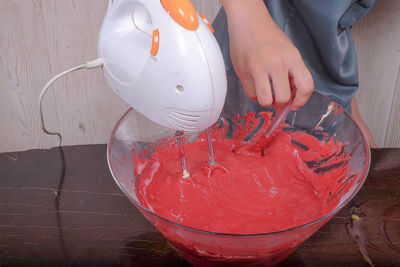 Midsection of chef preparing food in bowl