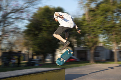 Portrait of skateboarder flip