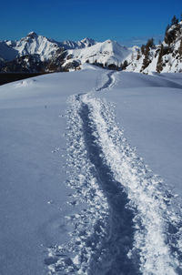 Scenic view of snow covered mountains against sky