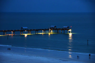 Scenic view of sea against clear blue sky at dusk