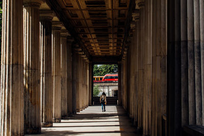 Rear view of woman walking in corridor