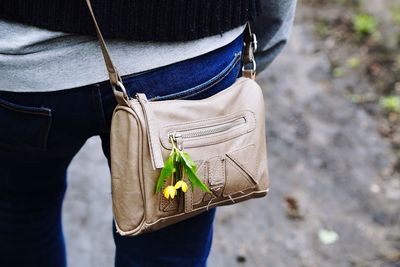 Midsection of woman wearing bag