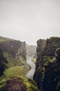 Scenic view of river and mountains against clear sky