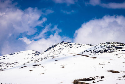 Scenic view of snow covered mountains against sky