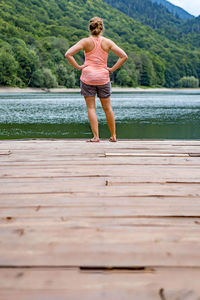 Rear view of woman walking in lake