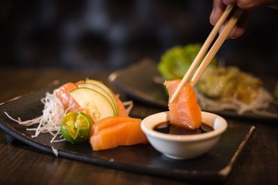 Cropped hand having seafood