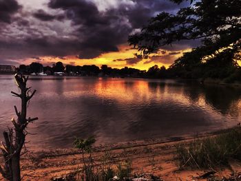 Scenic view of lake against sky at sunset