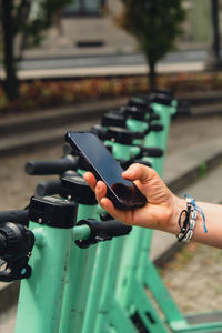 Cropped hand of man using mobile phone