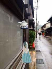 Clothes hanging on built structure against sky