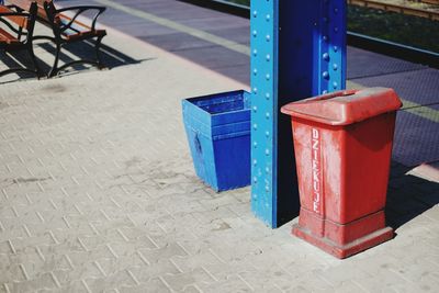 Garbage bins by pillar at railroad station platform