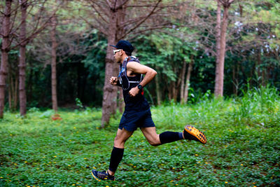 Full length of man running in forest