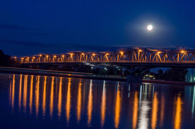 Illuminated bridge over danube river at night