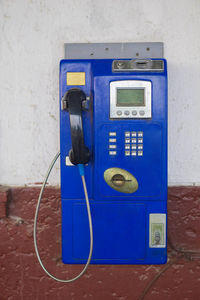 Close-up of telephone booth on wall