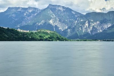 Scenic view of sea and mountains against sky