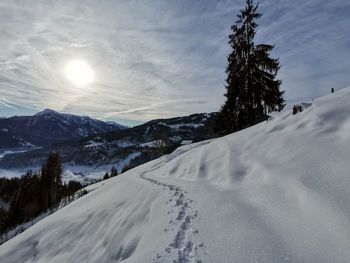 Scenic view of snow covered mountains against sky