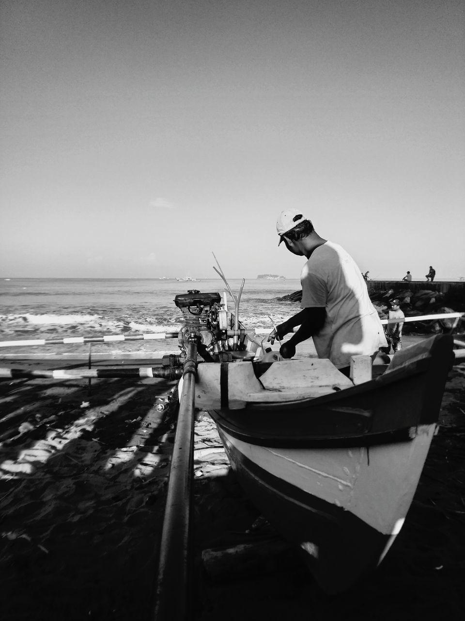 MAN STANDING AT BEACH