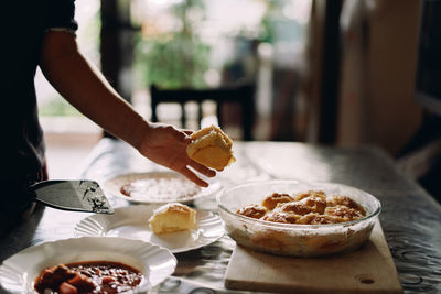 Midsection of man preparing food on table