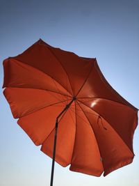 Low angle view of umbrella against clear sky