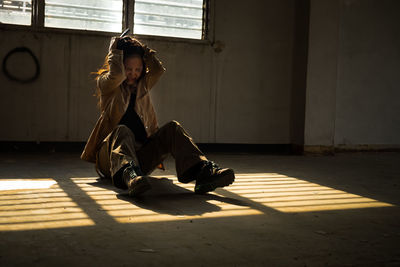 Young woman sitting on floor