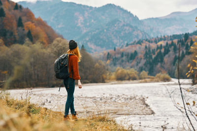 Rear view of man standing on mountain