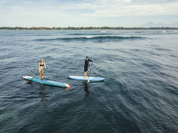 Aerial view of sup surfers