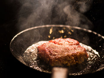 Close-up of meat in cooking pan