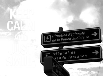Low angle view of information sign against sky