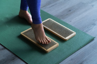 Low section of woman using mobile phone on table